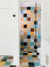 Bathroom with multi-color tile.