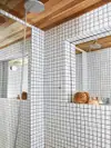 White tiled bathroom shower with cedar lining. 