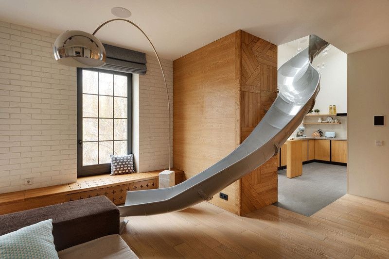 this apartment has a slide connecting its two floors