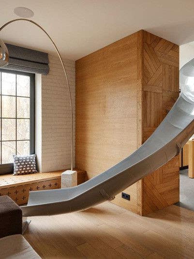 this apartment has a slide connecting its two floors