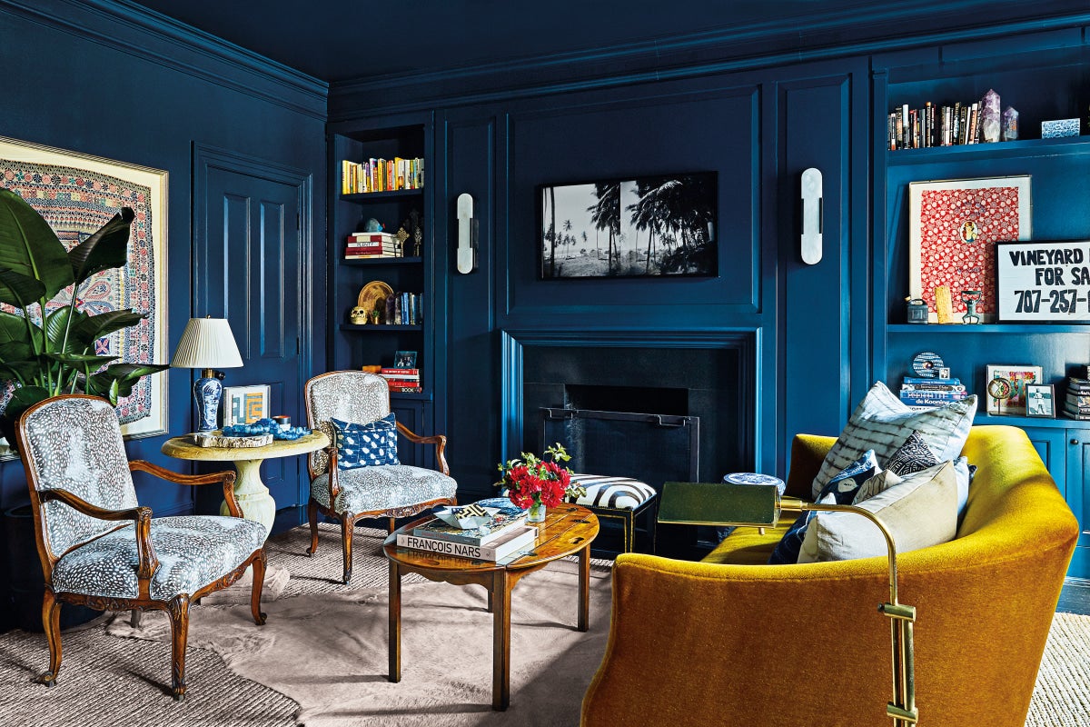 Living room with dark blue walls and built-in bookcases
