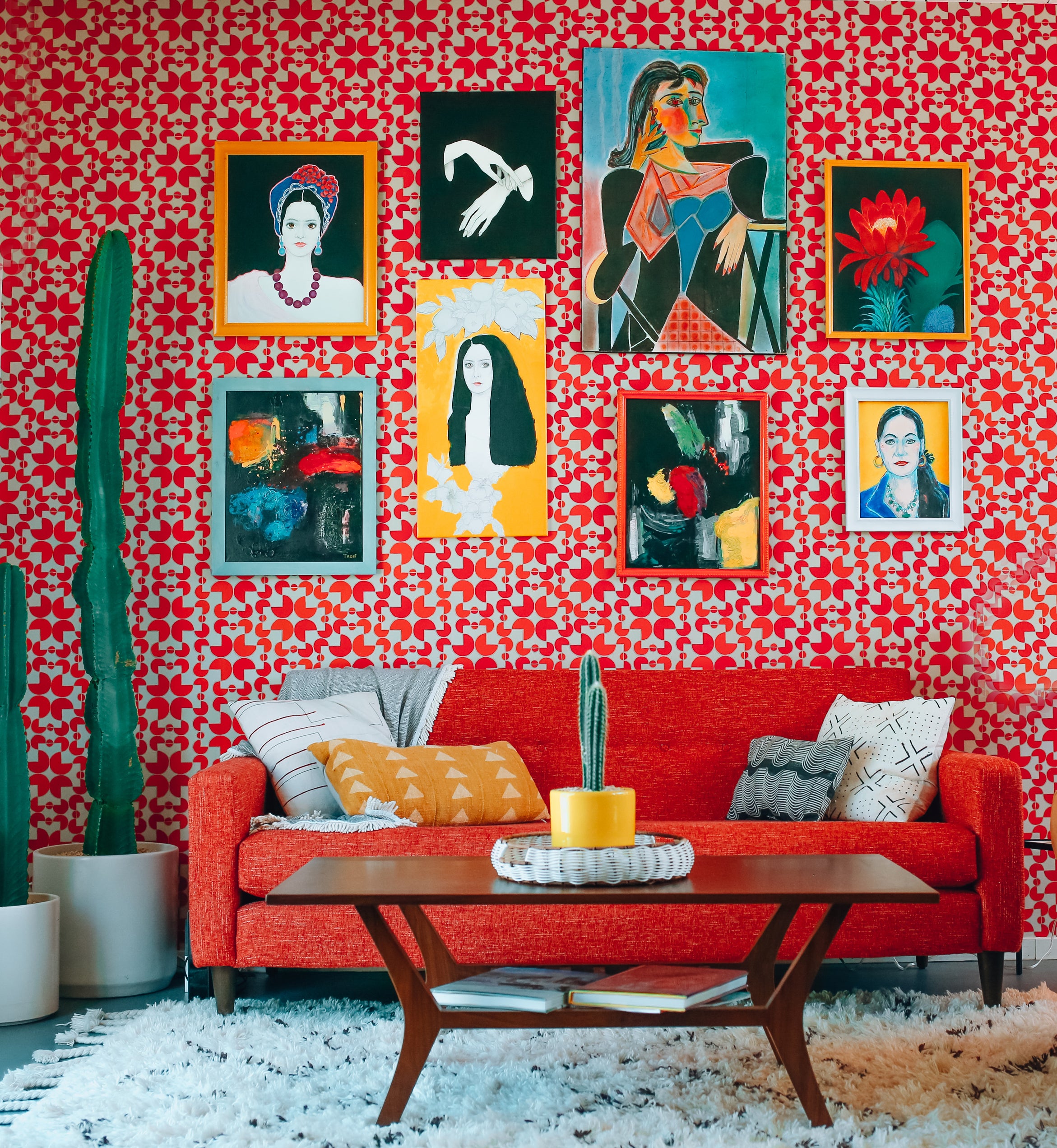 Gallery wall on wall with red wallpaper