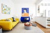 Living room with yellow couch and blue armchair