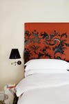 bedroom with orange vintage headboard