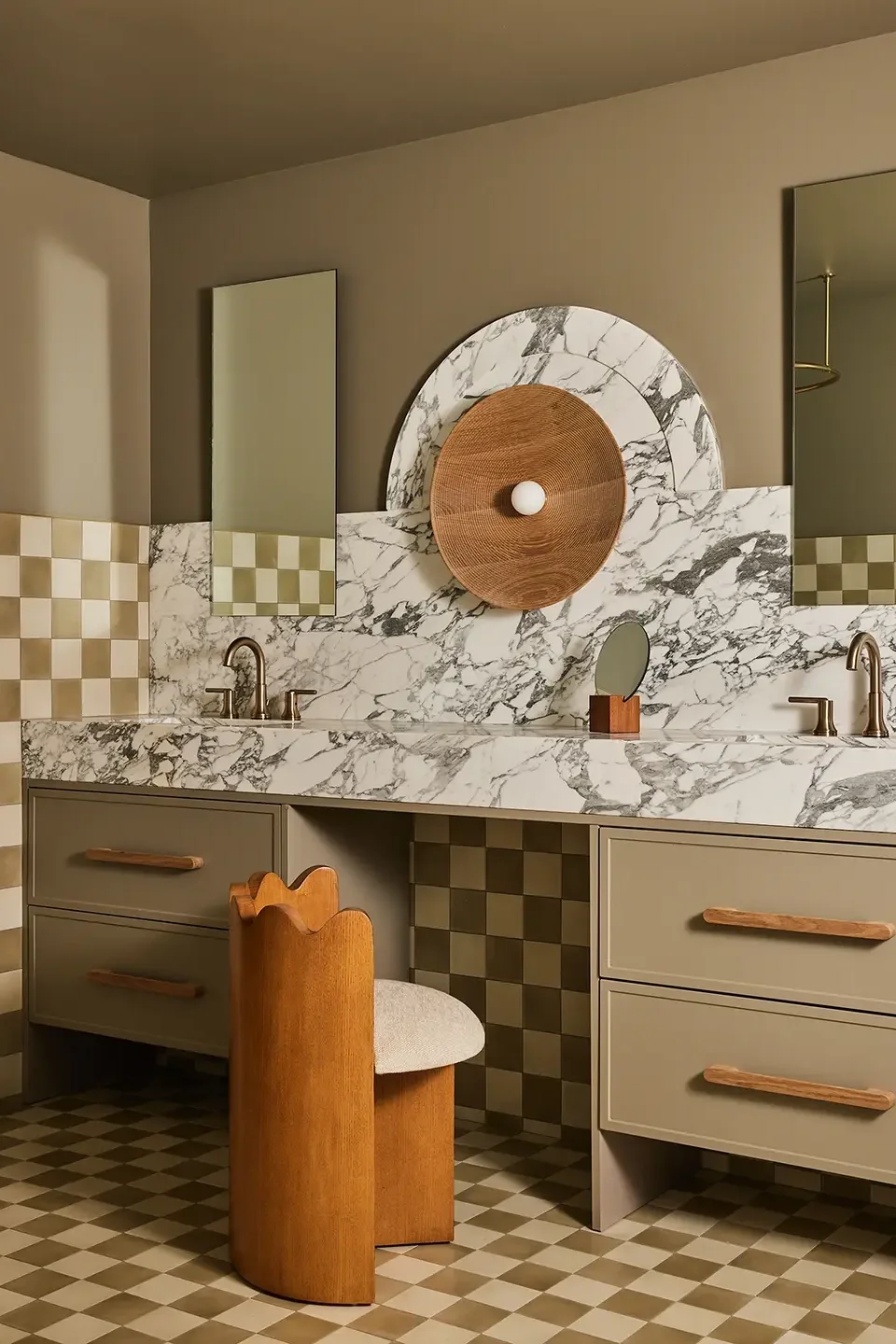 Bathroom with checkerboard tile, two vanities, and long marble countertop.