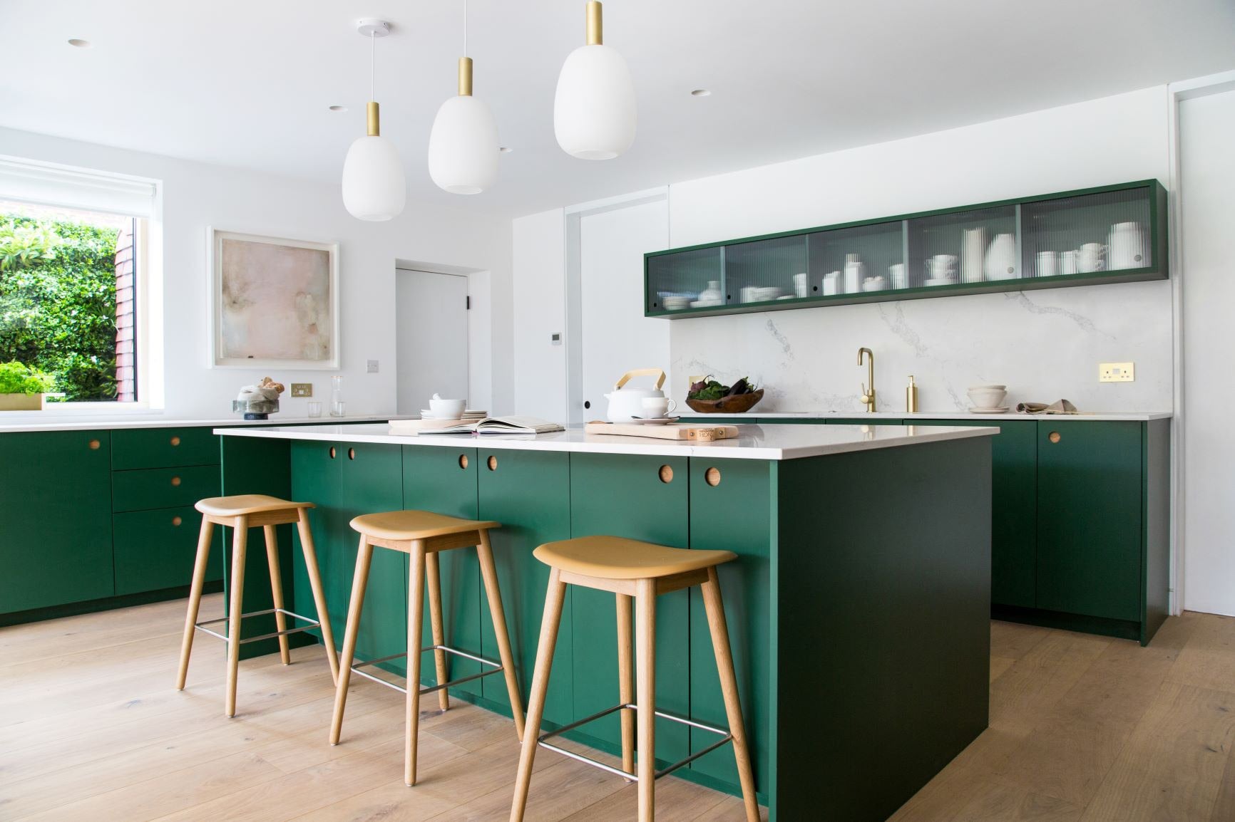 bright green kitchen island with three bar stools 