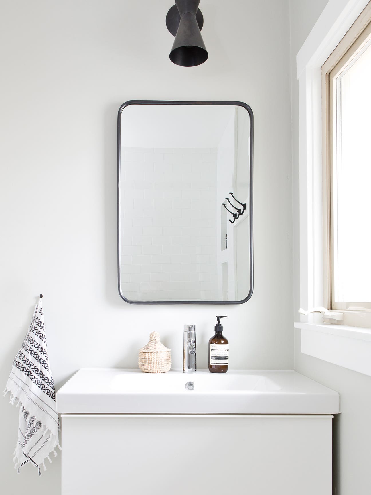 white bathroom with single sink vanity