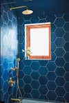 blue bathroom with hexagonal shower tiles
