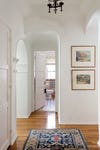 hallway photo wiht white paint and hardwood floors