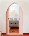 pointed bathroom archway with pink pocket doors