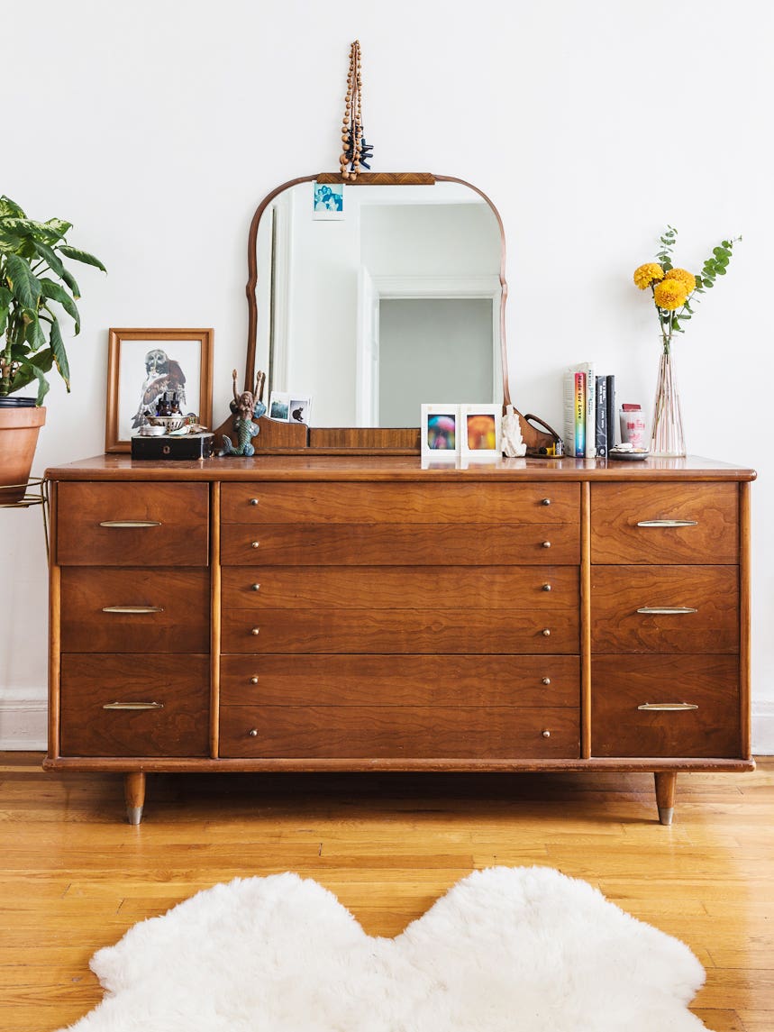 vintage wood dresser with vanity mirror leaning on it