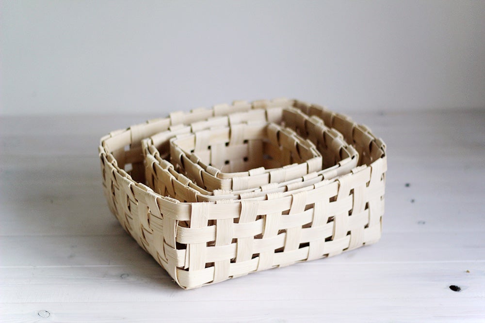 three woven baskets sitting inside one another