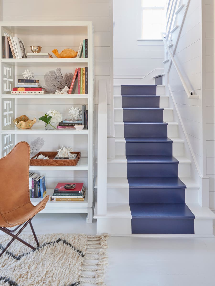 white beach house with blue painted stripe down the stairs