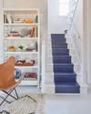 white beach house with blue painted stripe down the stairs
