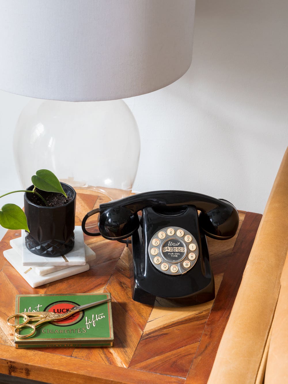 nightstand with retro phone and glass lamp