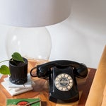 nightstand with retro phone and glass lamp