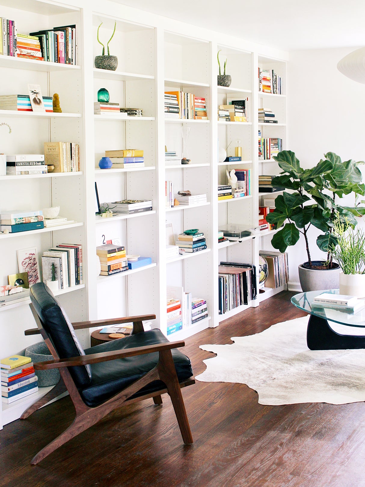 living room with a large white built in bookcase
