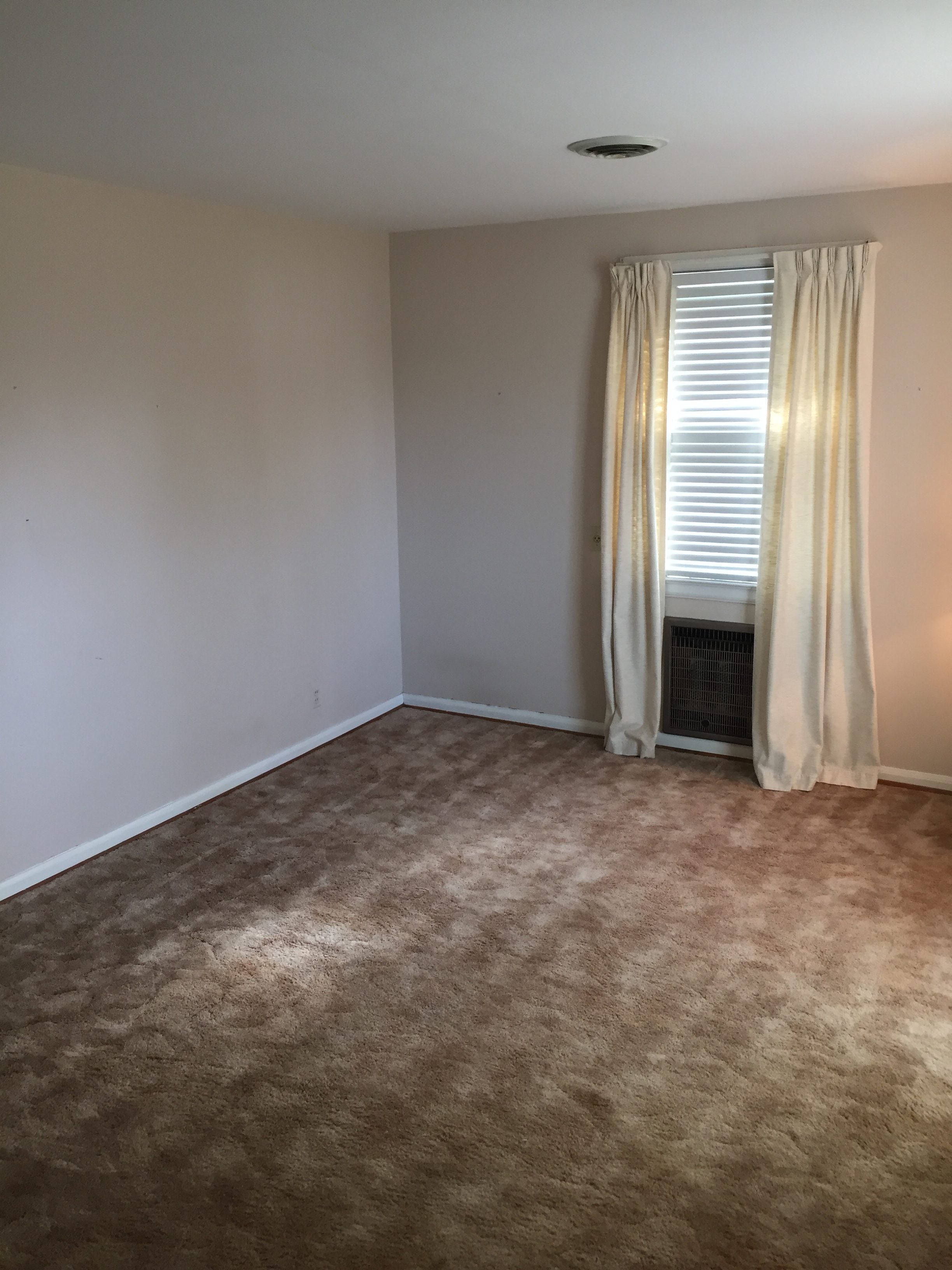 before image of a bland living room with blank walls