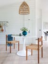White circle dining table with blue flower vase.