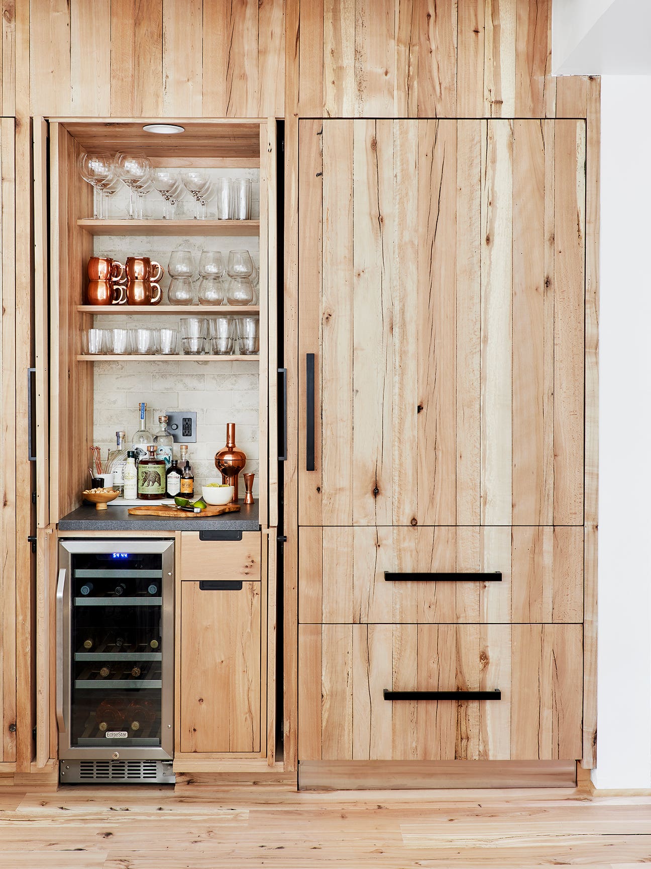 shot of the outside of a wood refrigerator with a bar nook next to it