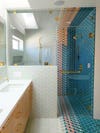 large shower with blue hexagon tiles