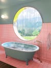 pink and green bathroom with a round window over the tub
