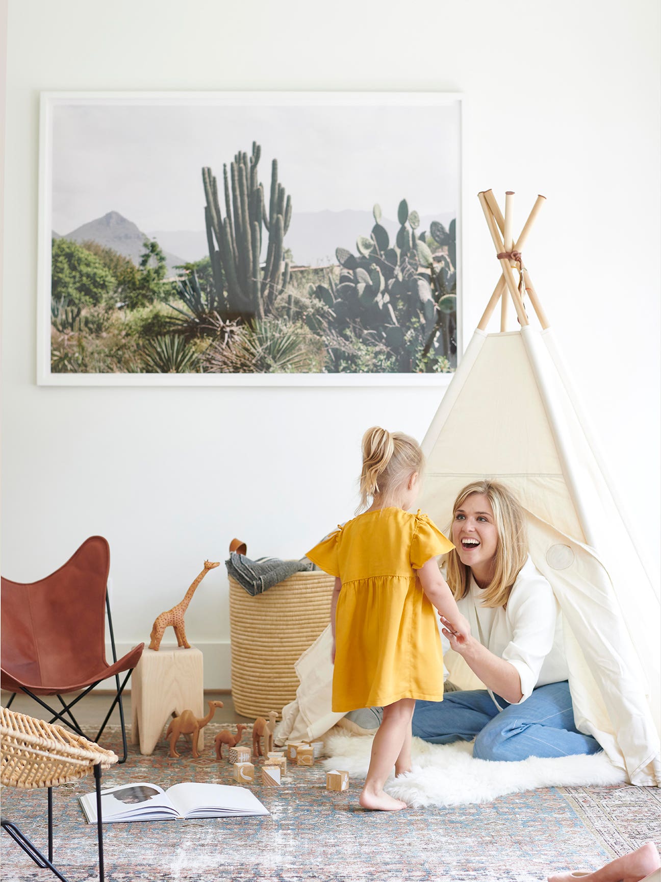 carly nance sitting in a tepee looking at her daughter