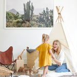 carly nance sitting in a tepee looking at her daughter