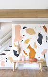 giant terrazzo shapes on a wall by the stairs