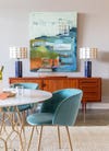 blue velvet dining room chairs with a mid century credenza in the background