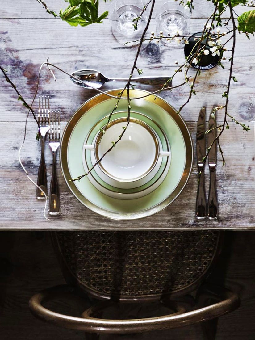 dining table with green plates and large branches
