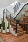 modern staircase with a glass enclosed bar underneath