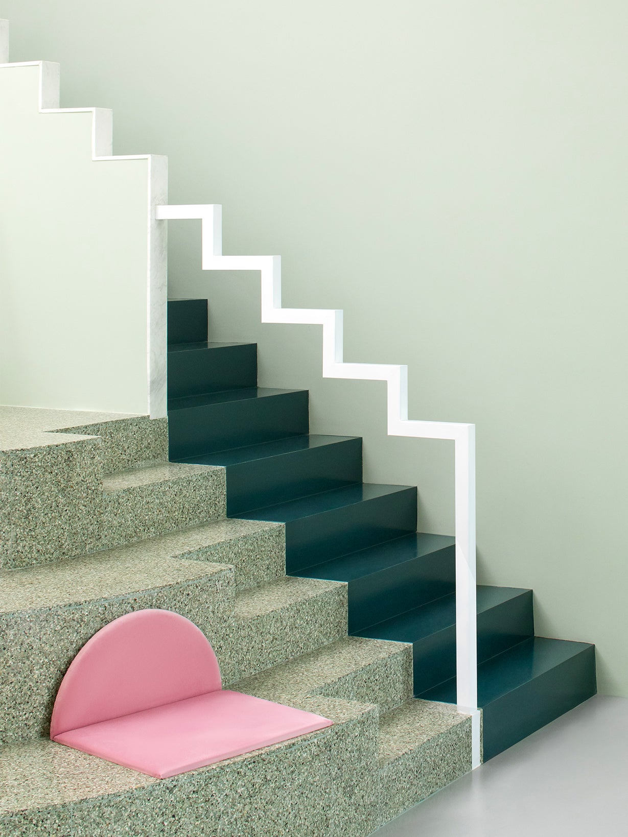 green terrazzo stairs with a white zigzag handrail