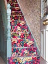 staircase carpeted with bold floral fabric