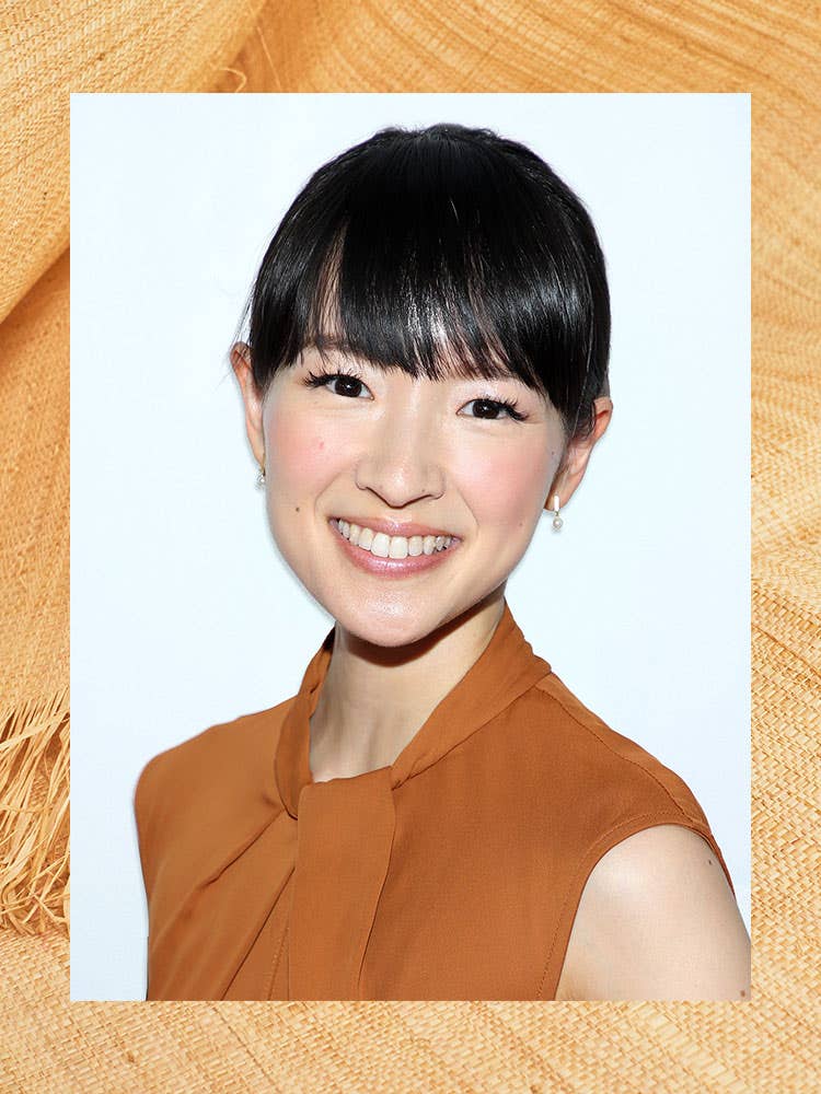 portrait of marie kondo in a brown dress against a border of wood