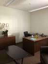 brown office furniture and a swivel chair