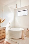 round bathtub within shower stall