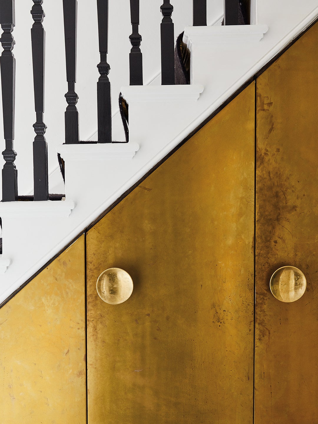 brass doors on under-the-stairs nook