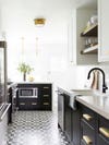 black white and brass kitchen with mosaic floor tiles