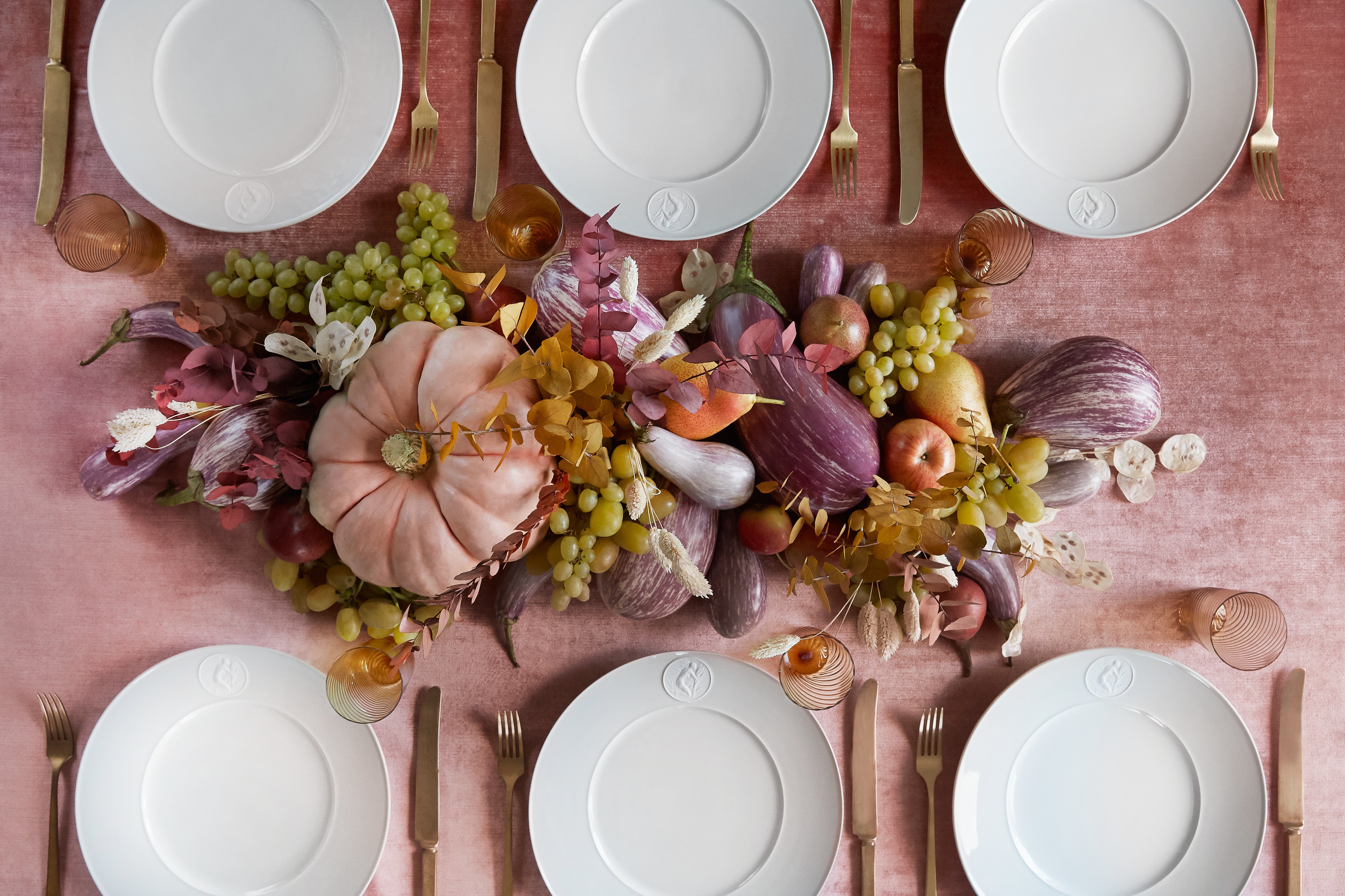 white plates on a pink table