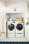 laundry closet with blue ocean wallpaper