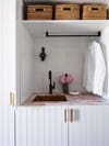 pink marble tiled counter wiht brass sink