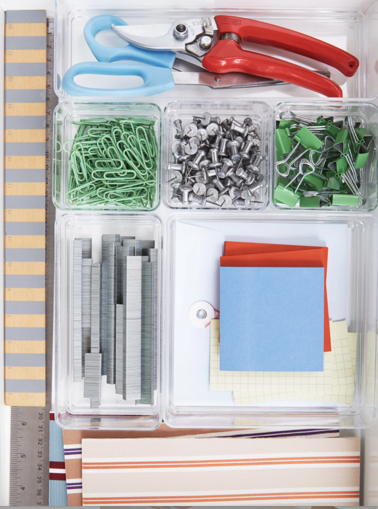 items sitting in a desk drawer compartment