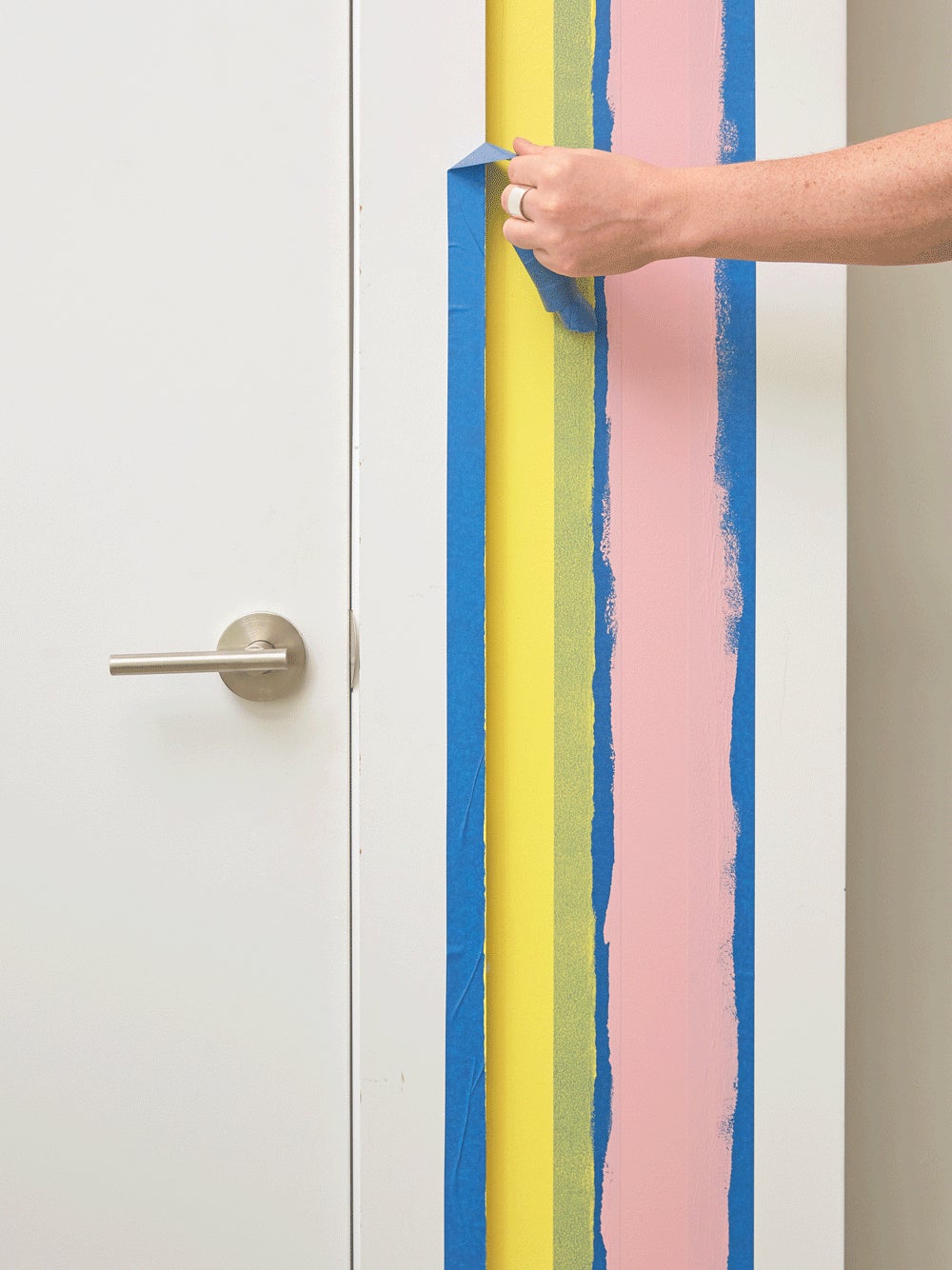 testing out painted stripes with tape on the wall