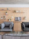 living room with a wall to wall wood pegboard