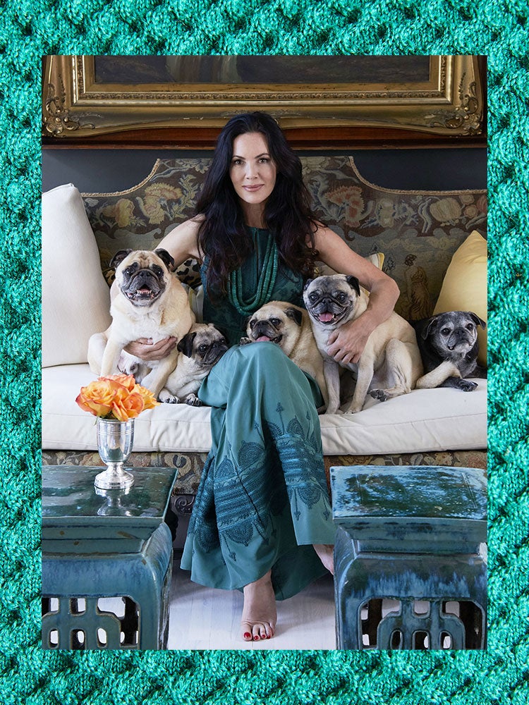 mary mcdonald sitting on a sofa with her dogs