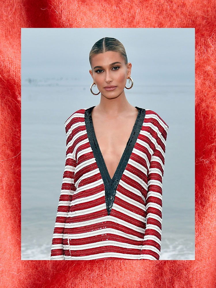 hailey bieber in a red and white dress at the beach