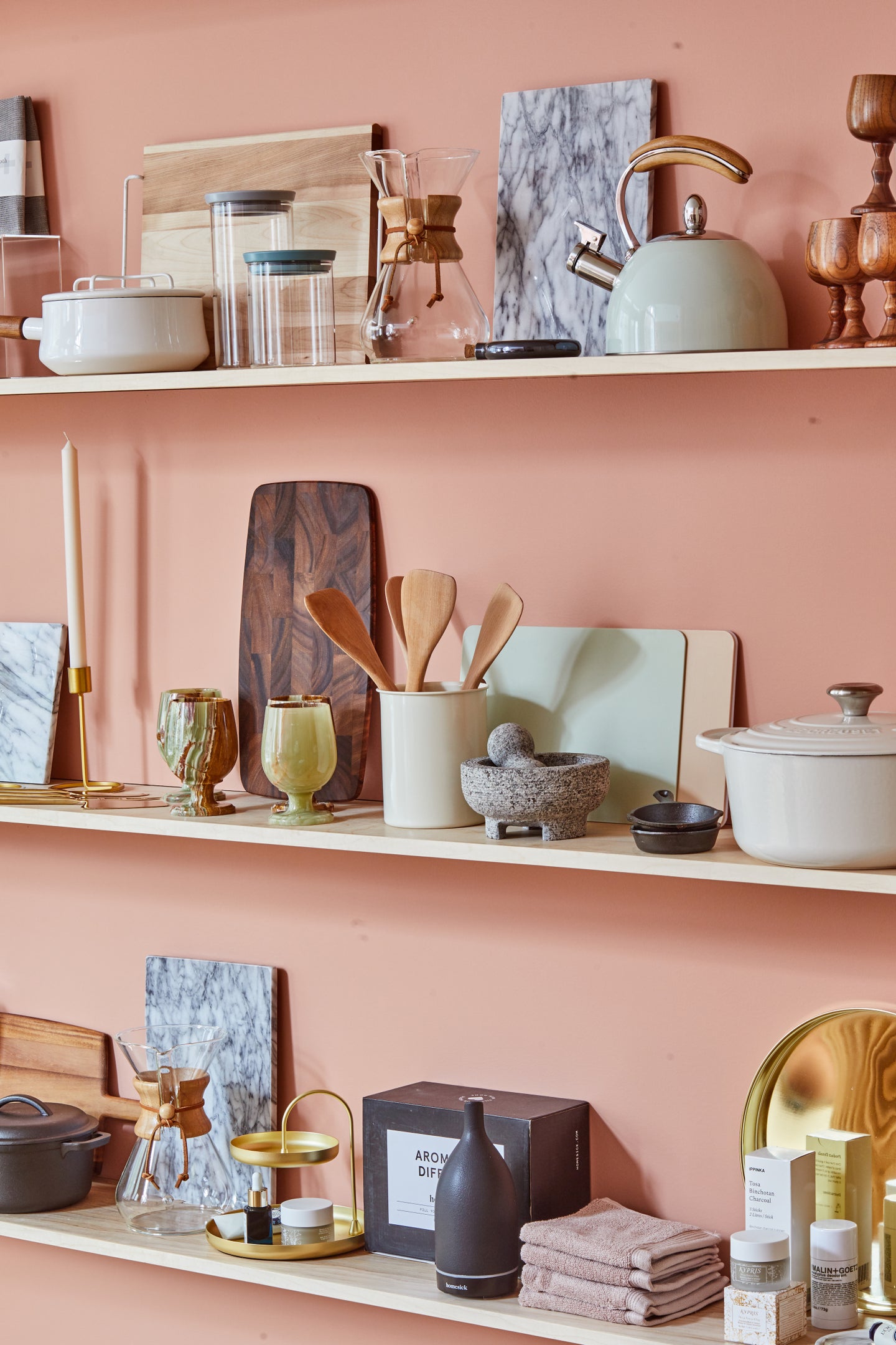 pink wall with shelves home goods