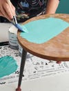 painting blue color on a wood table