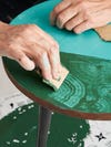 taking cardboard to a table to create swirl design